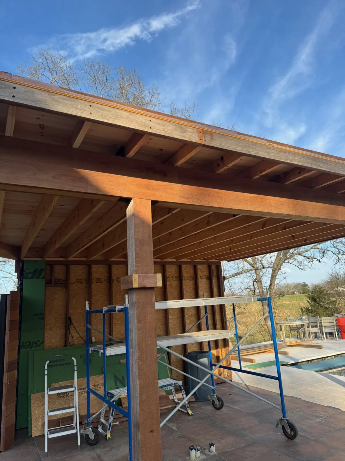 Finished ipe pergola beside a pool