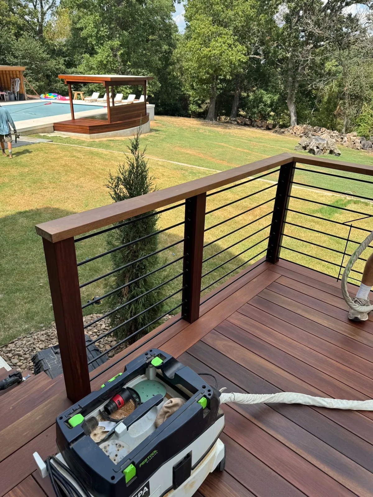 Cable rail ipe deck overlooking the pool and pergola