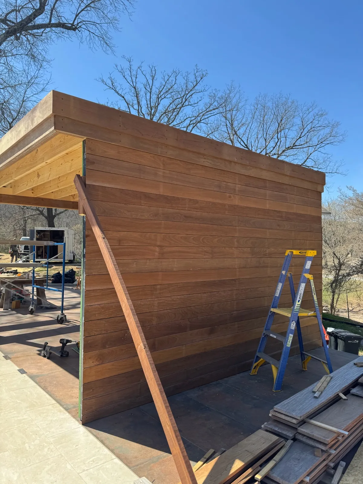 Ipe privacy wall corner below a cedar eave
